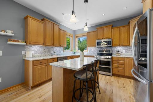 The heart of the home is the beautifully appointed kitchen, complete with granite countertops, stainless steel appliances, under-cabinet lighting and abundant cabinetry.