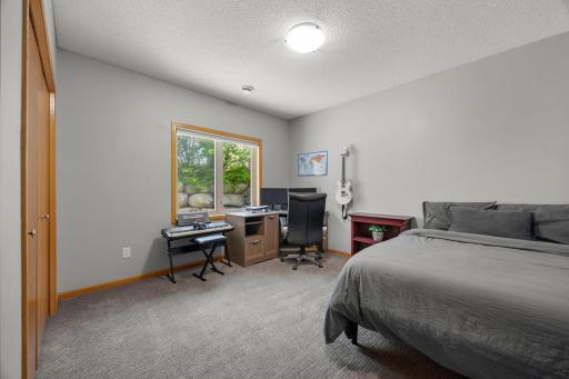 The lower-level fourth bedroom is generously sized and features carpeting and a lookout window, and is just steps from a 3/4 bathroom.