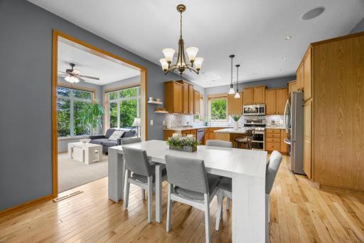 The inviting dining room, perfect for sharing a meal, offers direct access to the sunroom.