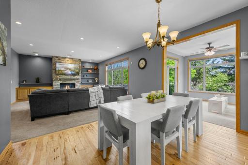 Another view of the dining area highlighting the adjacent living room and sunroom.