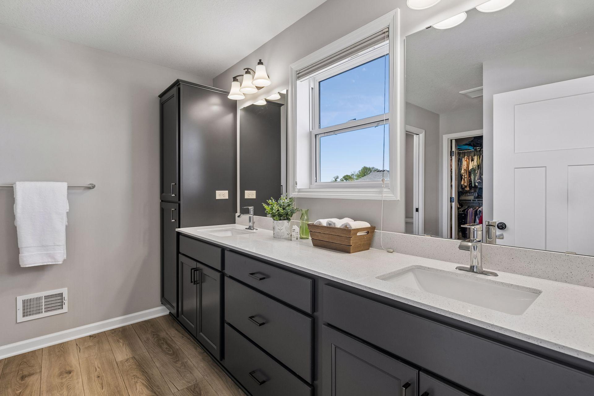 Primary bath with dual sink vanity and linen storage