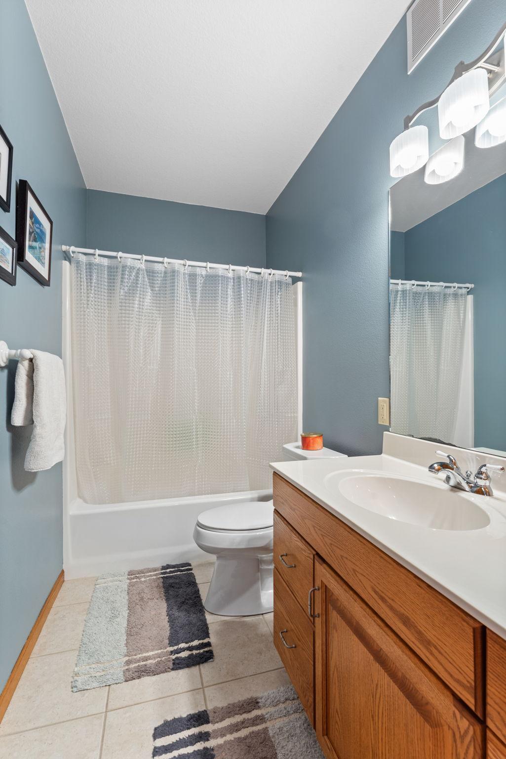 A full bathroom completes the lower level with a hallway closet nearby.