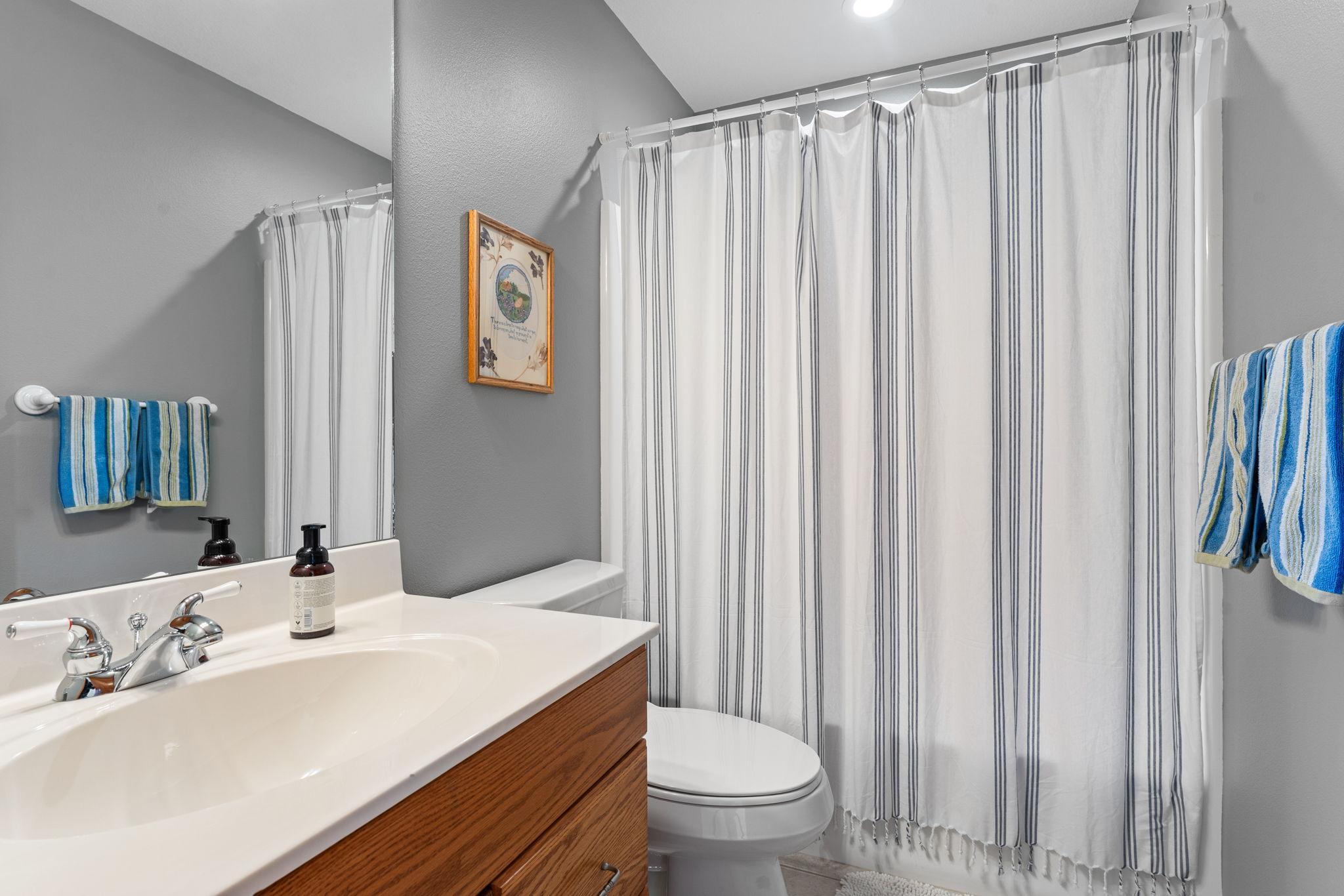 A full bathroom completes the upper level with a hallway closet nearby.