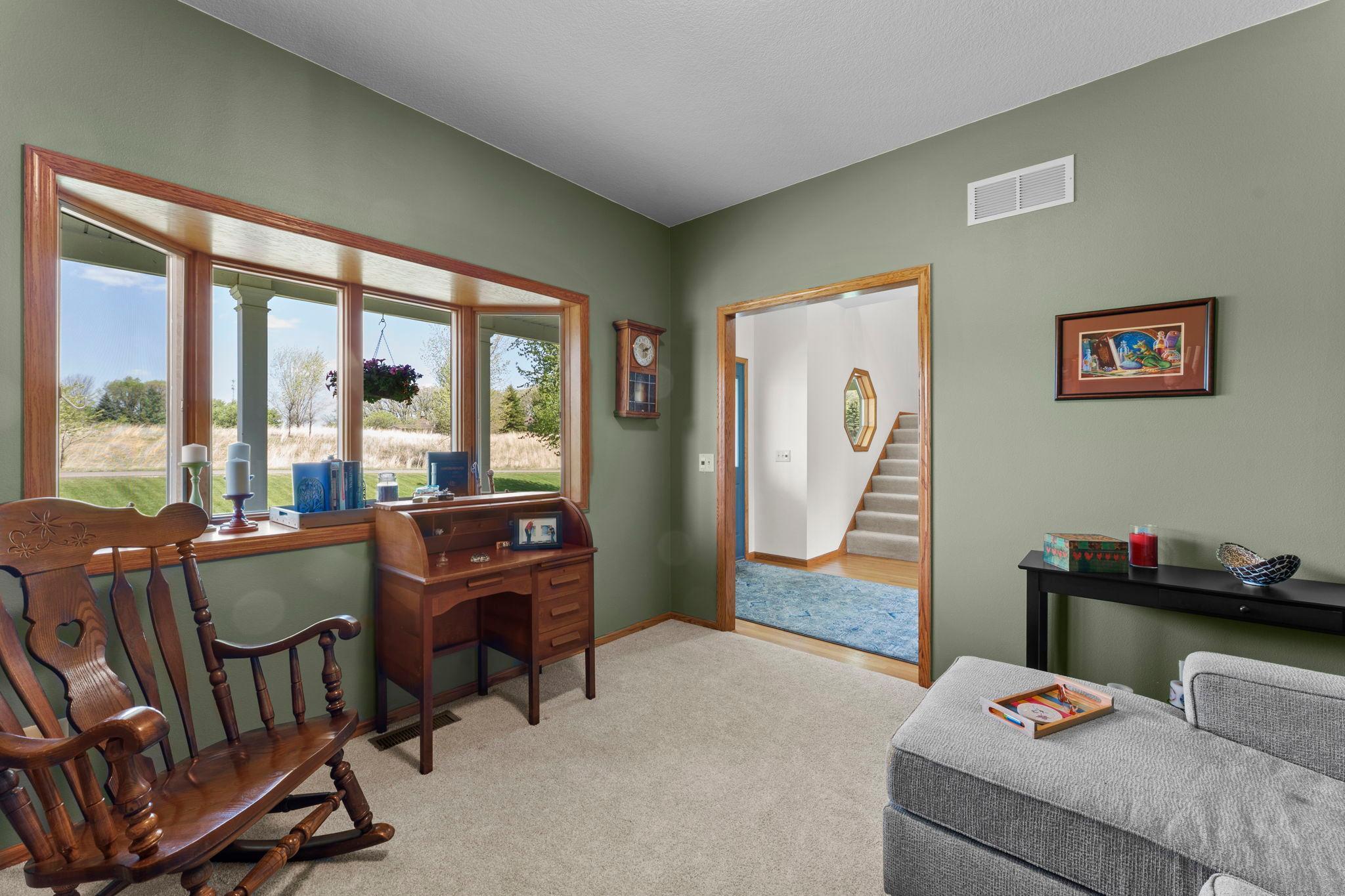 Versatile office space overlooks the front patio and works equally well as a library, sitting room, or bonus room.