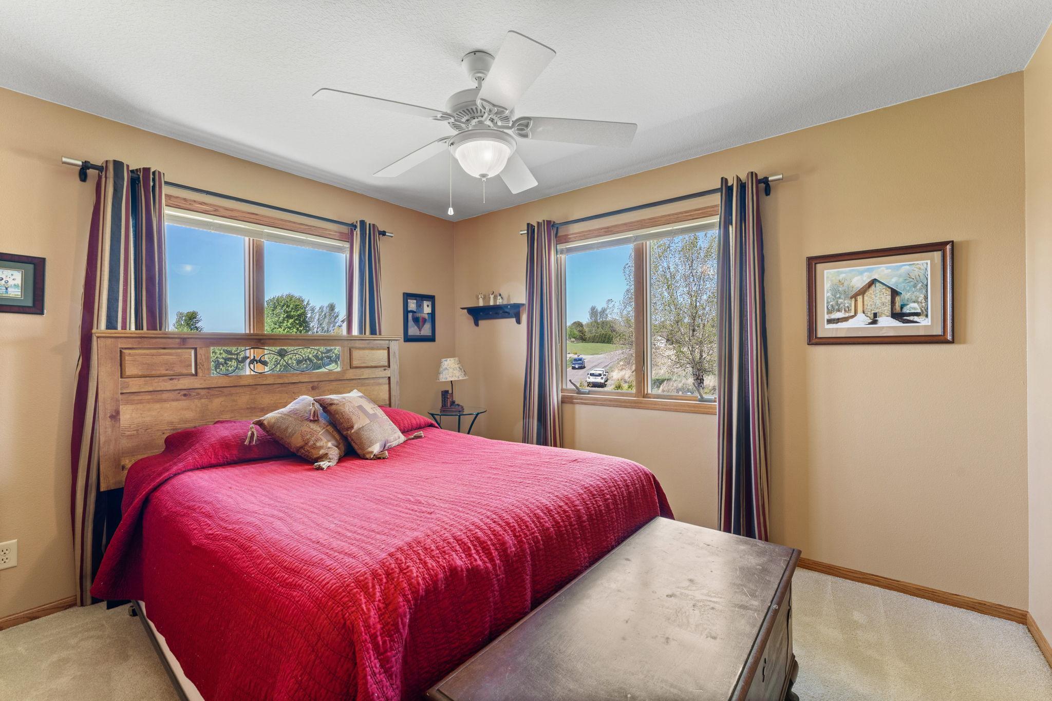 A third upper-level bedroom with front yard views filling the space with natural light.