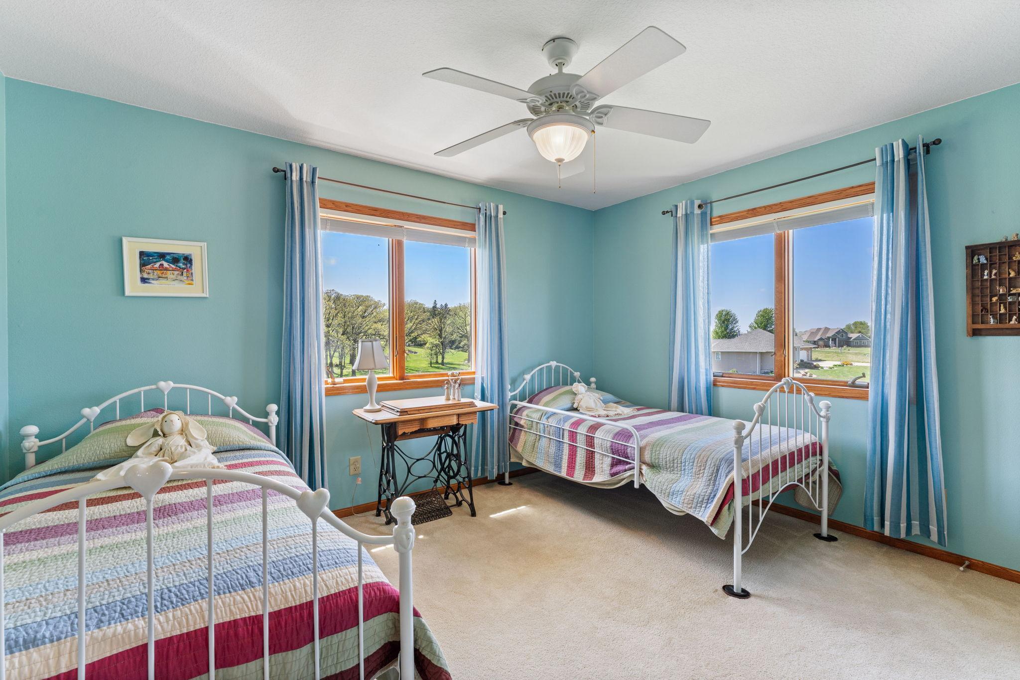 The second upper-level bedroom includes a walk-in closet and backyard pond views