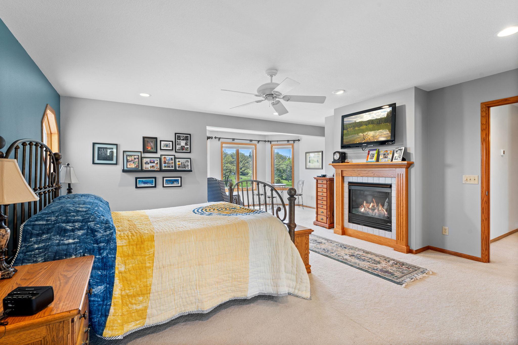 The primary is bright and spacious with a charming fireplace.