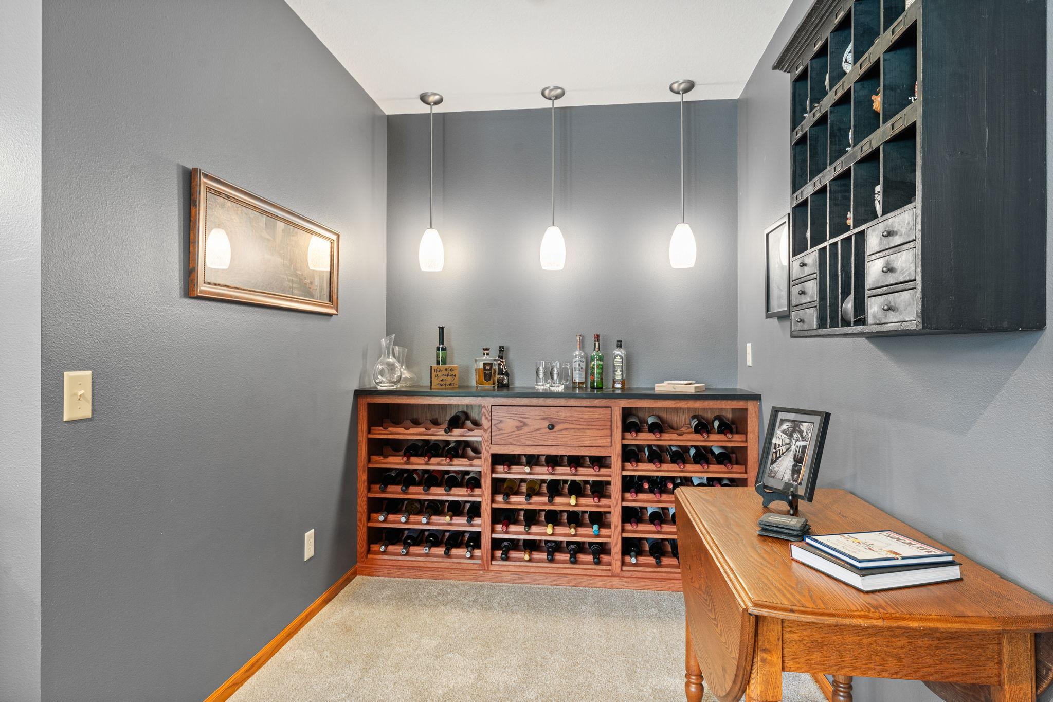 Alongside the bar is a charming wine bar alcove that adds both elegance and function