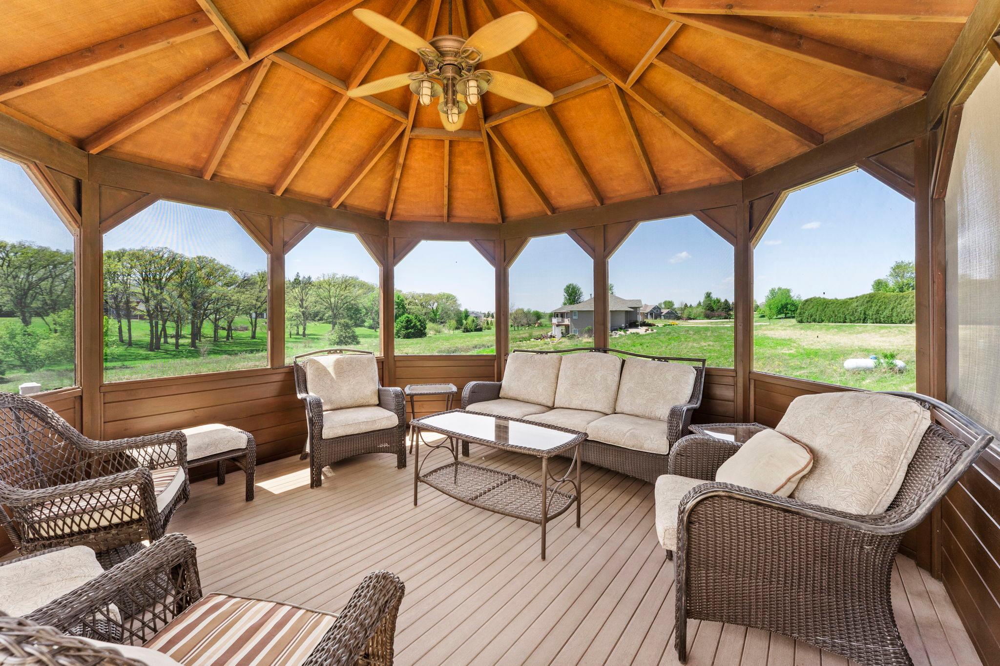 A fully screened gazebo with electricity and a ceiling fan for comfortable outdoor entertaining.
