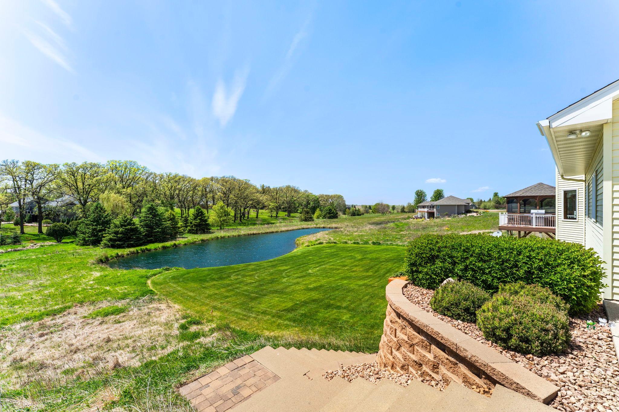 Enjoy expansive views of the backyard and pond.