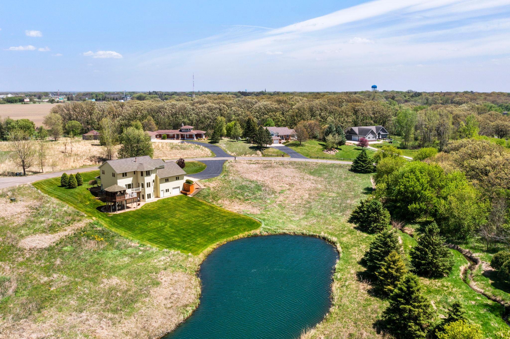 An overview of the property showcasing the expansive backyard and pond.