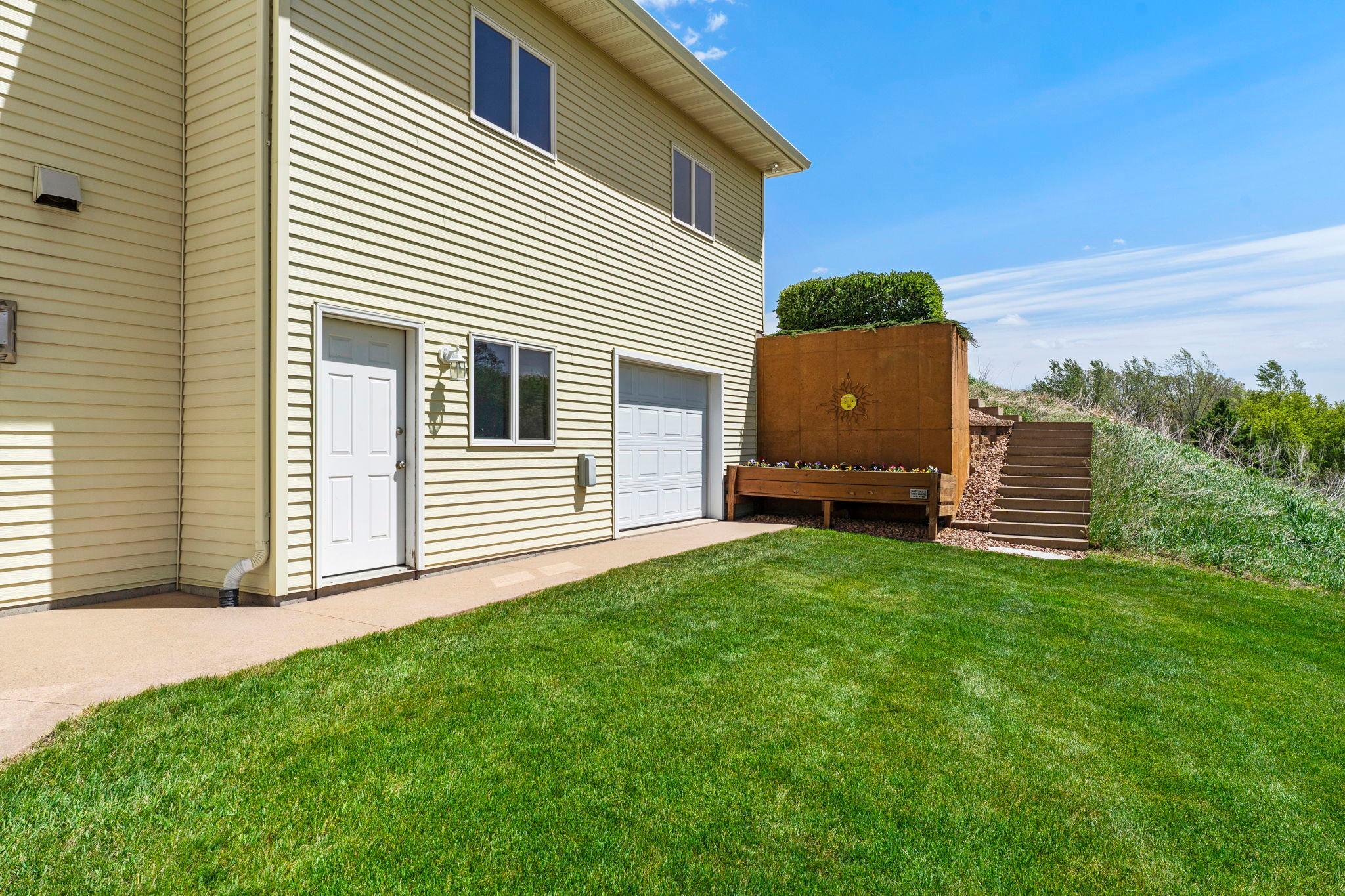 A spacious spancrete garage with backyard access is perfect for lawn equipment, recreational vehicles, or hobby projects