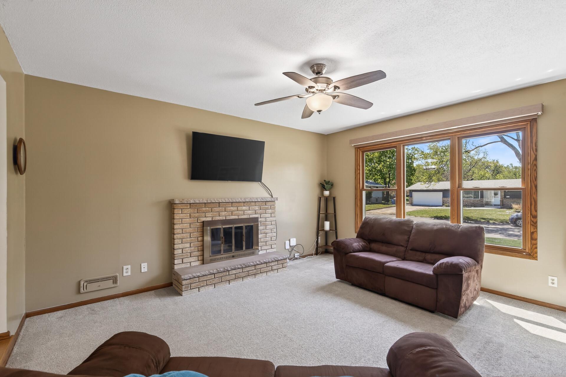 Spacious living room with wood-burning brick fireplace