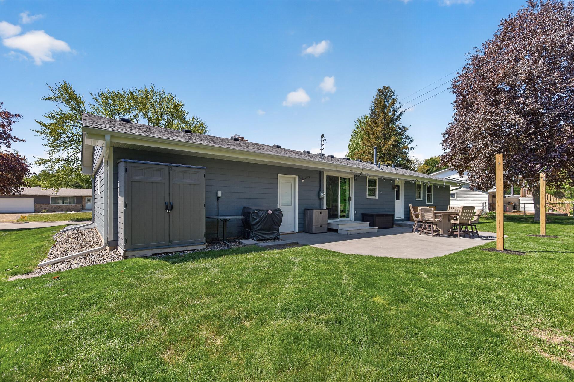 Backyard view featuring large stamped concrete patio