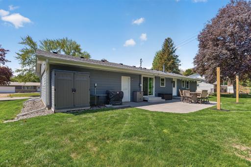 Backyard view featuring large stamped concrete patio