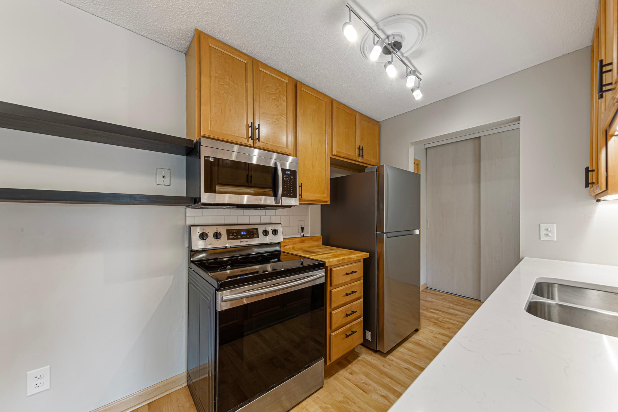 Kitchen with updated maple cabinets and stainless appliances