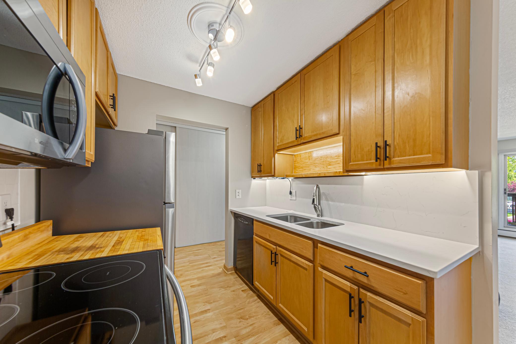Kitchen updates include new sink and queartz counter tops.