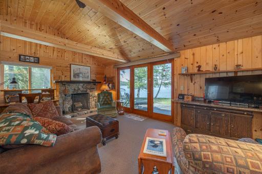 Lakeside living room with stone wood burning fireplace