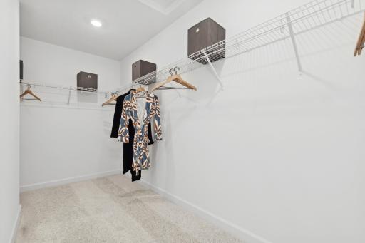 Photo is of the actual model. The primary bedroom walk-in closet.
