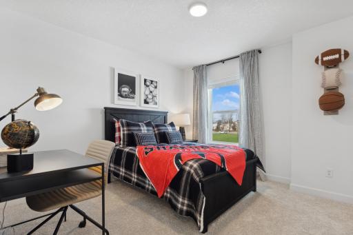 Photo is of the actual model. One of the three generously sized upper level secondary bedroom with a spacious closet.