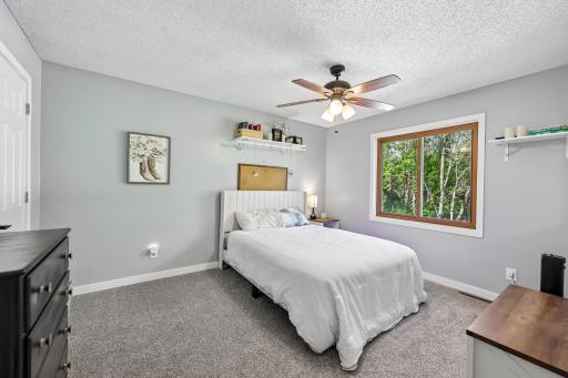 Primary Bedroom with walk-in closet, attached primary bathroom, and plush carpet installed