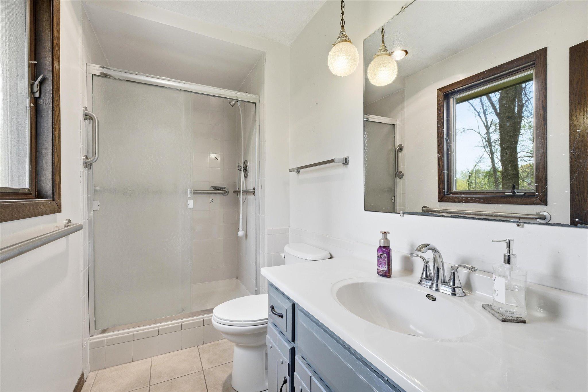 The 3/4 primary bath includes tile flooring and shower.