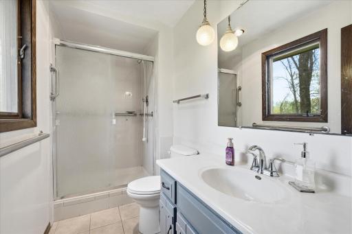The 3/4 primary bath includes tile flooring and shower.