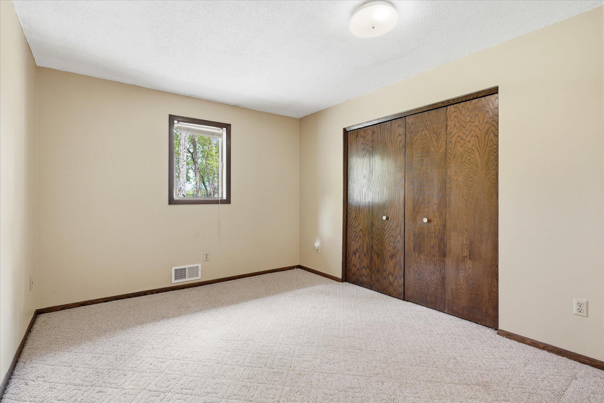 Bedroom #3 on the main level of the home which also overlooks the backyard.