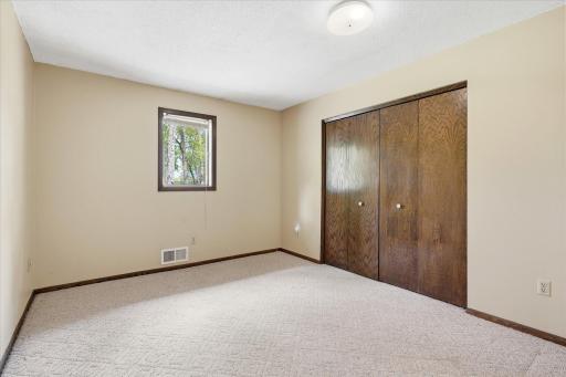 Bedroom #3 on the main level of the home which also overlooks the backyard.
