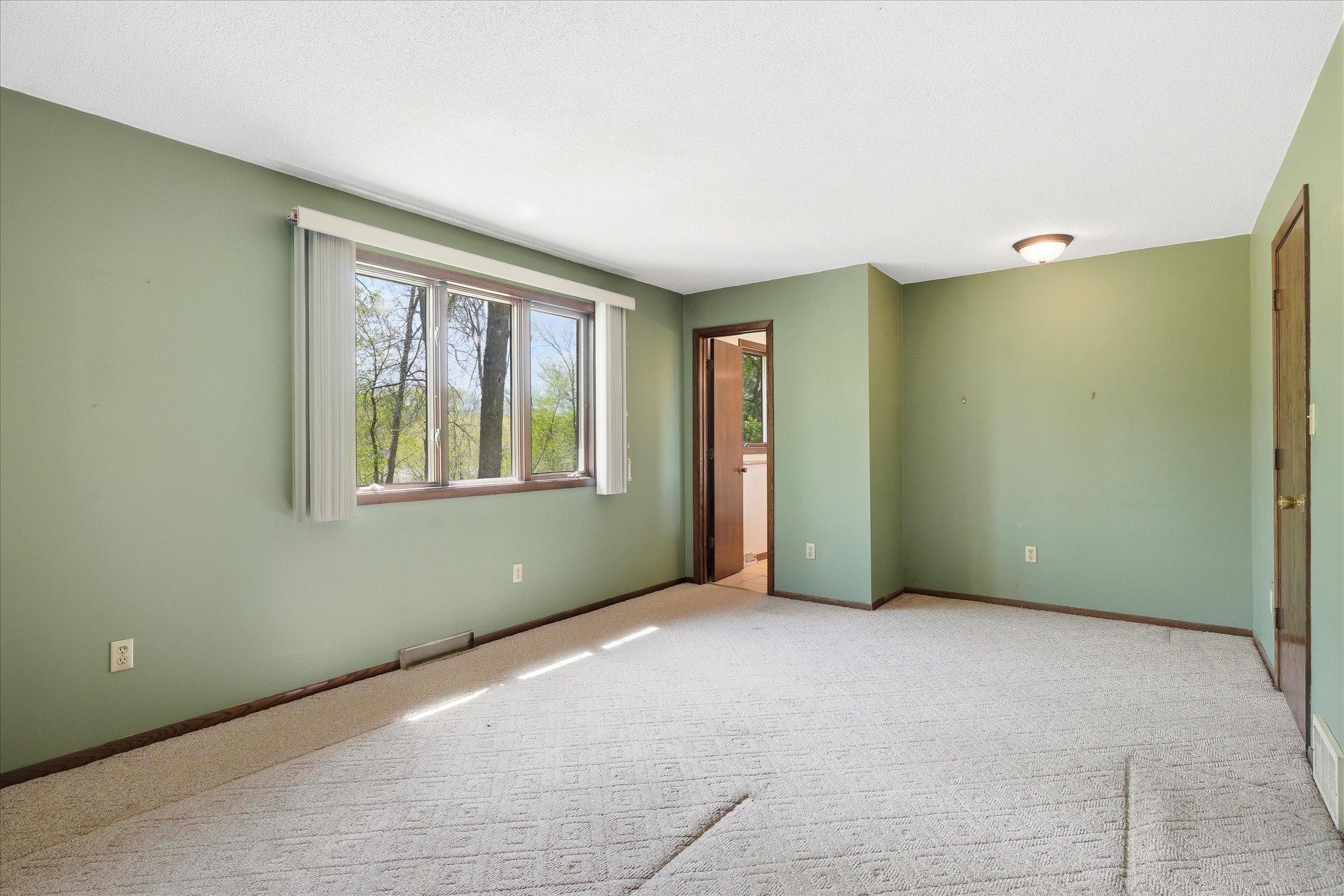 View in the primary bedroom into the 3/4 bath area