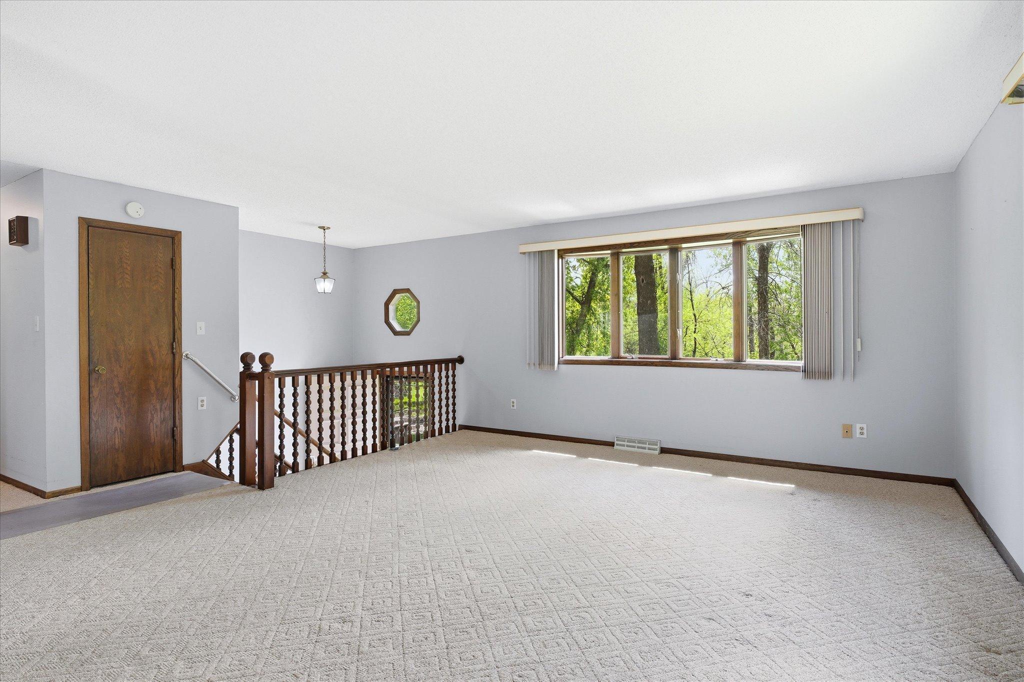 The huge living room with plenty of sunlight flowing in is perfect for gatherings and is open to the dining area and close to the kitchen.