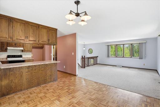 View of the living room area which opens to the dining room and kitchen area. Notice the hardwood flooring.