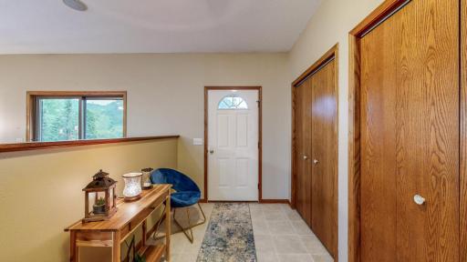 Great view of the large entry, tiled flooring and three large closet spaces.