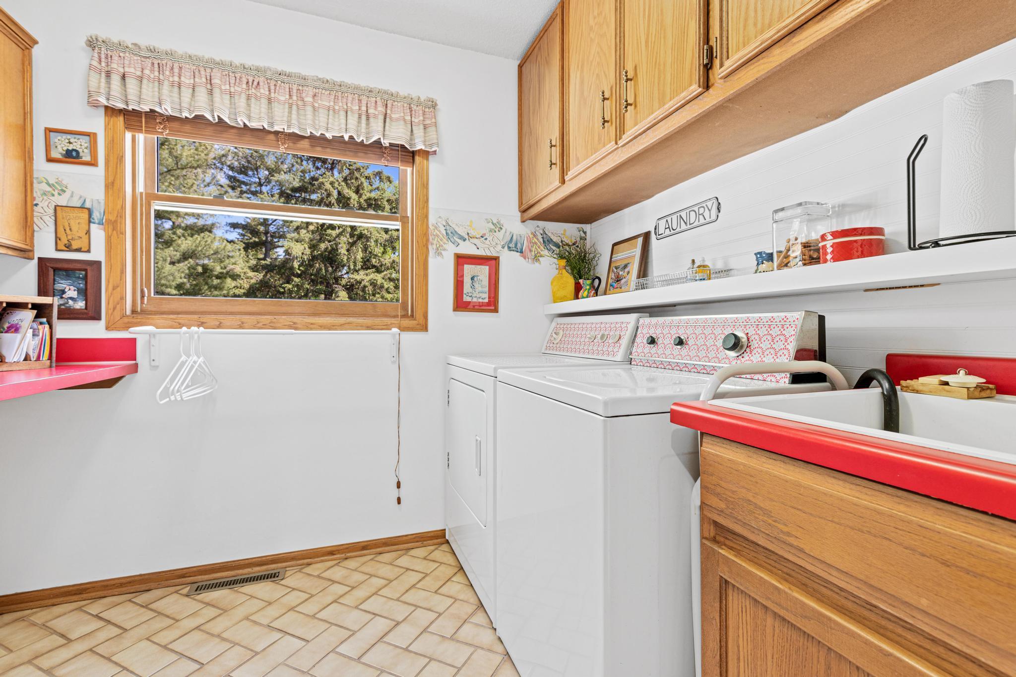 Main level laundry room with excellent storage and workspace. Overlooks the backyard.