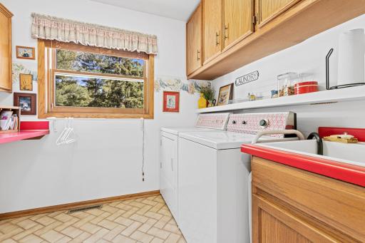 Main level laundry room with excellent storage and workspace. Overlooks the backyard.
