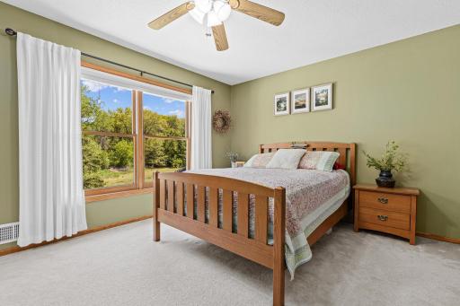 Large upper-level primary suite with beautiful natural light and serene views.