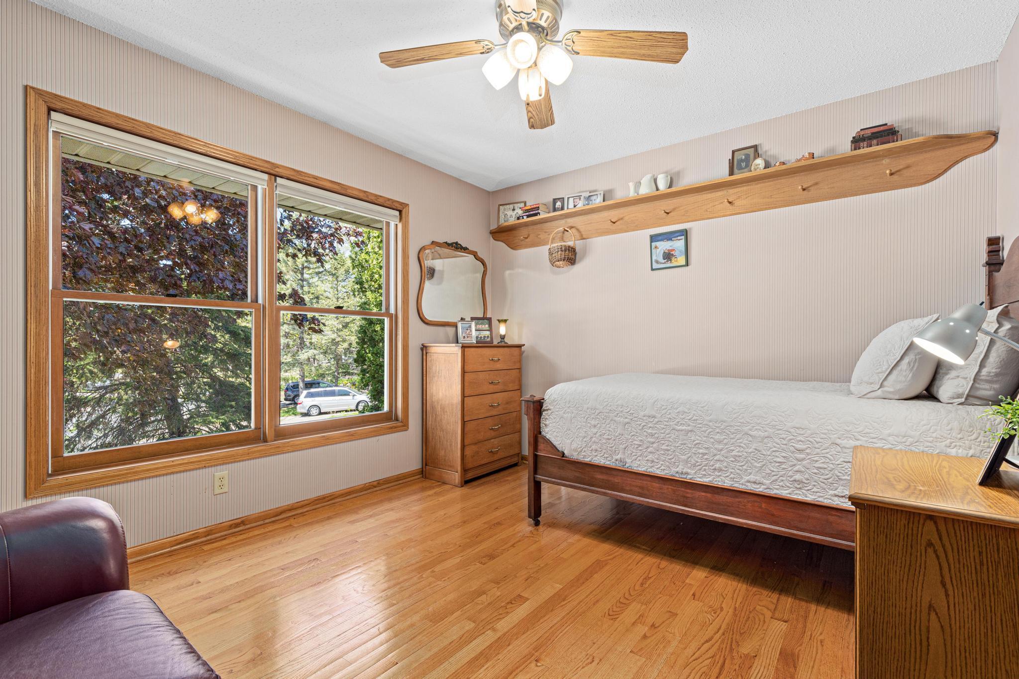 Hardwood floors, neutral paint colors and great natural light in one of four bedrooms upstairs.