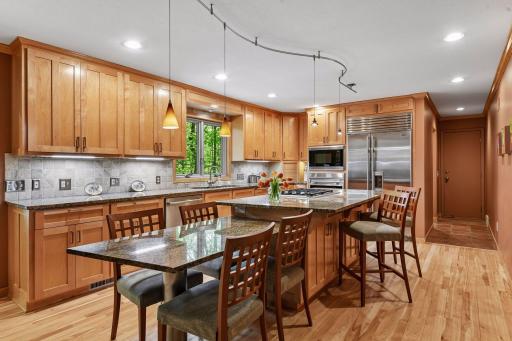 Seamless center island flow w cooktop, dining and bar seating.