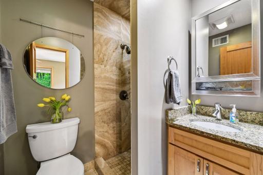 Primary 3/4 bath ensuite. Fully tiled shower, granite counter and maple cabinet. Kohler fixtures.