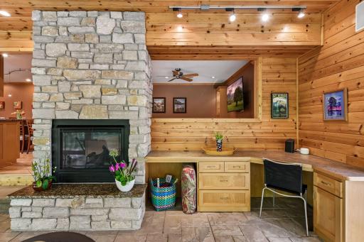 See-through gas fireplace and built in desk/buffet. Open to great room/tv.