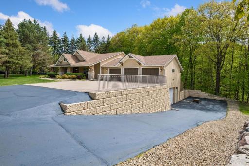 Concrete upper drive and lower asphalt w new clear coat. Engineered retaining wall! Lots of options for a basketball hoop!