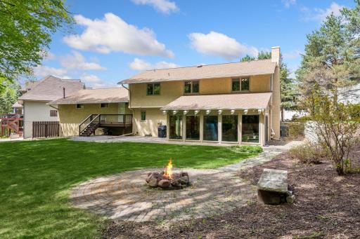 Four season porch overlooks peaceful and expansive back yard.