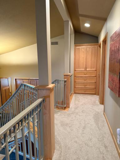 Linen closet at end of upper hallway outside primary bedroom. New carpet throughout upper level.
