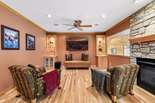 Great room w speakers, built in cabinetry and open to four season porch.
