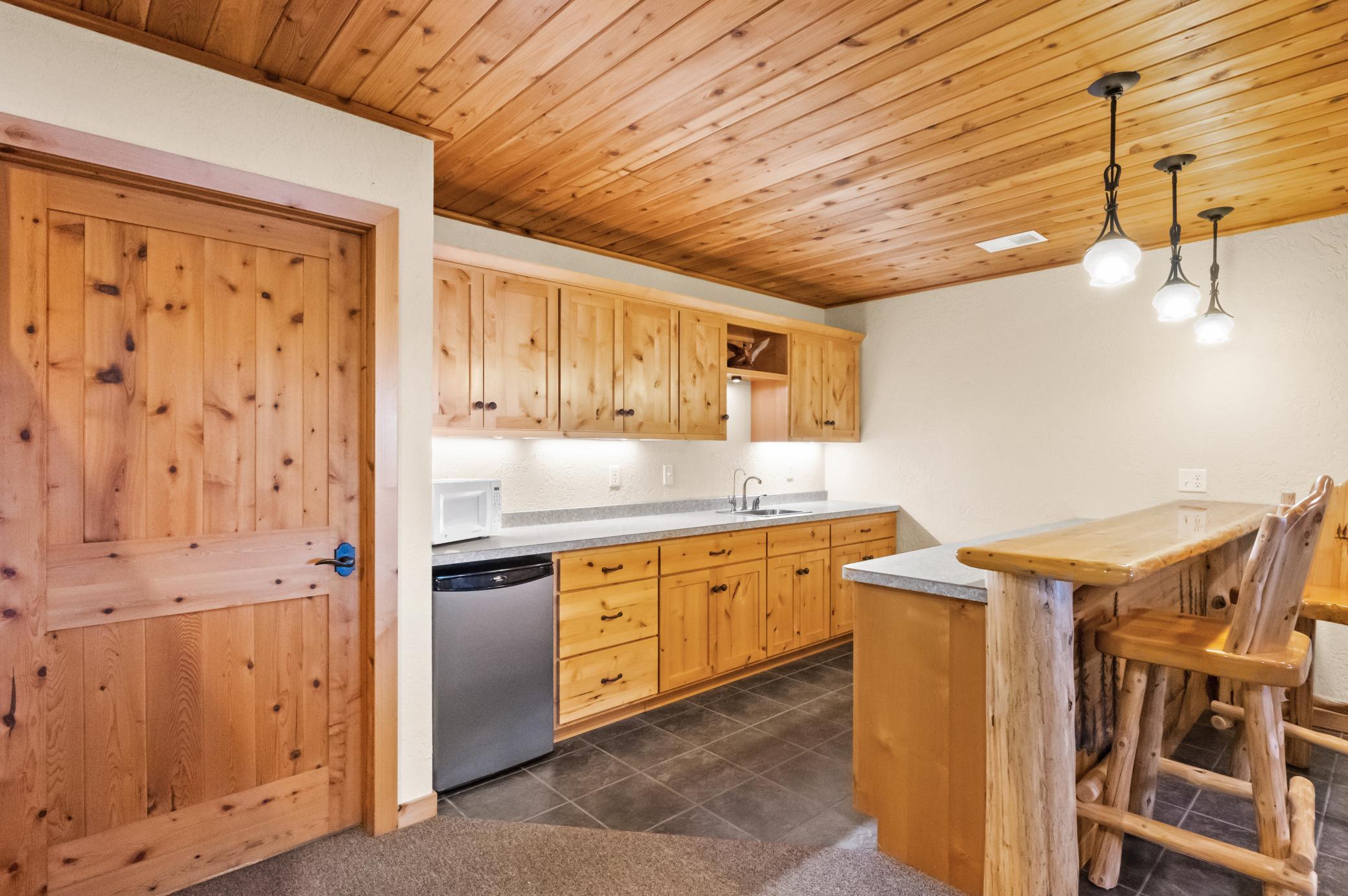 Large wet bar with beautiful ceramic tile flooring