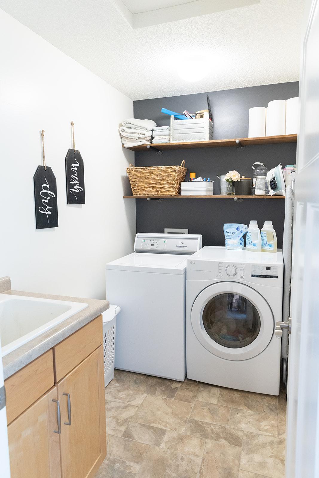 Upper level laundry room, complete with a utility sink. Yes, that's a SpeedQueen washer... IYKYK.