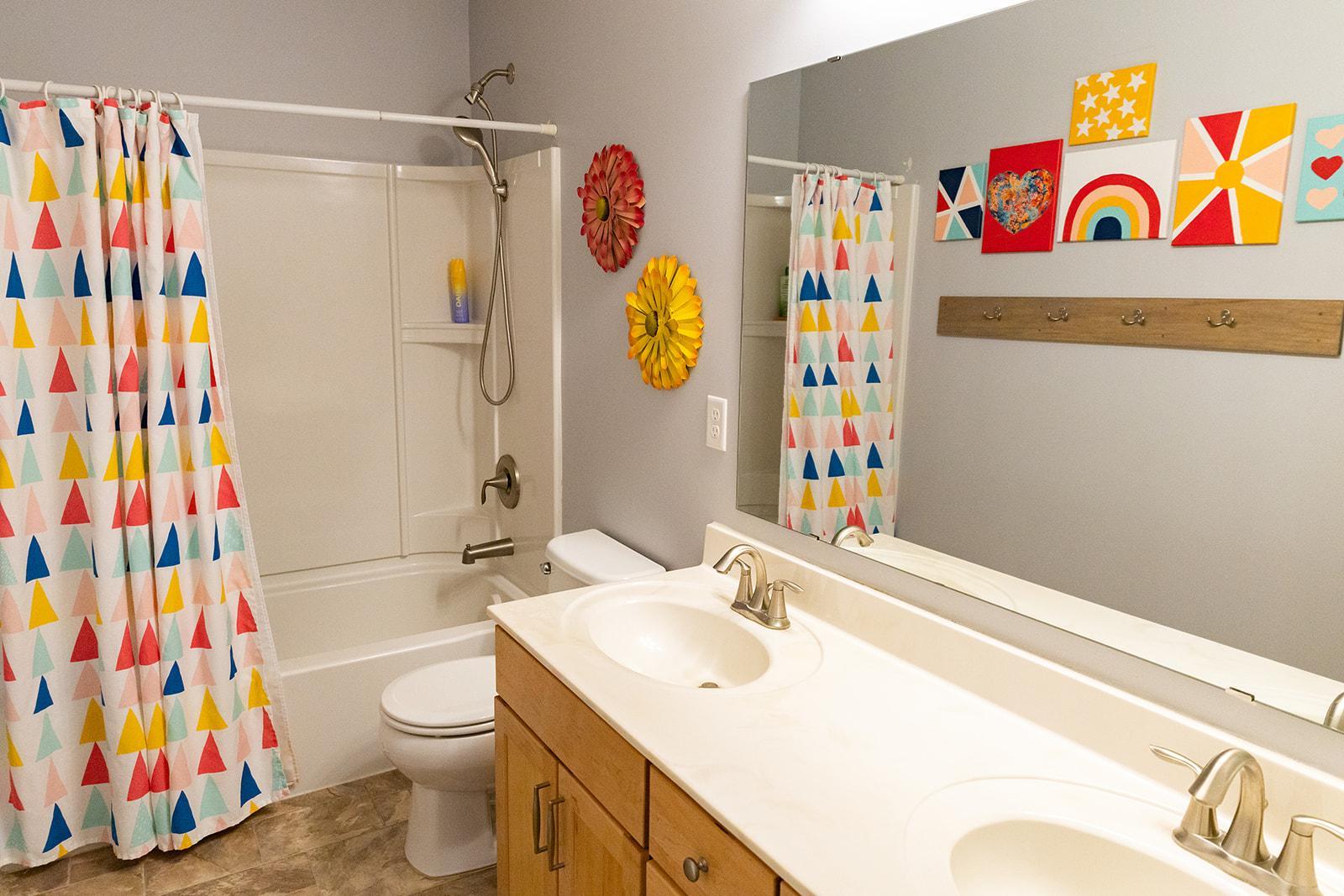 Upper level full bath has dual sinks.