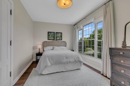 Impressive main bedroom boasting expansive windows, fantastic natural light, durable flooring, and a generous layout.