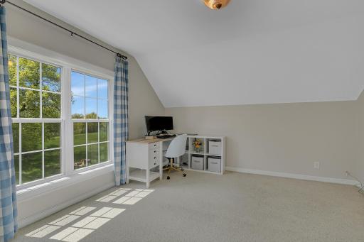 A different perspective showcasing the wonderful architectural lines of the sloped ceiling and how beautifully the natural light fills the entire room.
