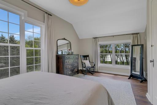 A true private retreat! This spacious main bedroom offers a peaceful escape with stunning, elevated views of the water through the large back windows.